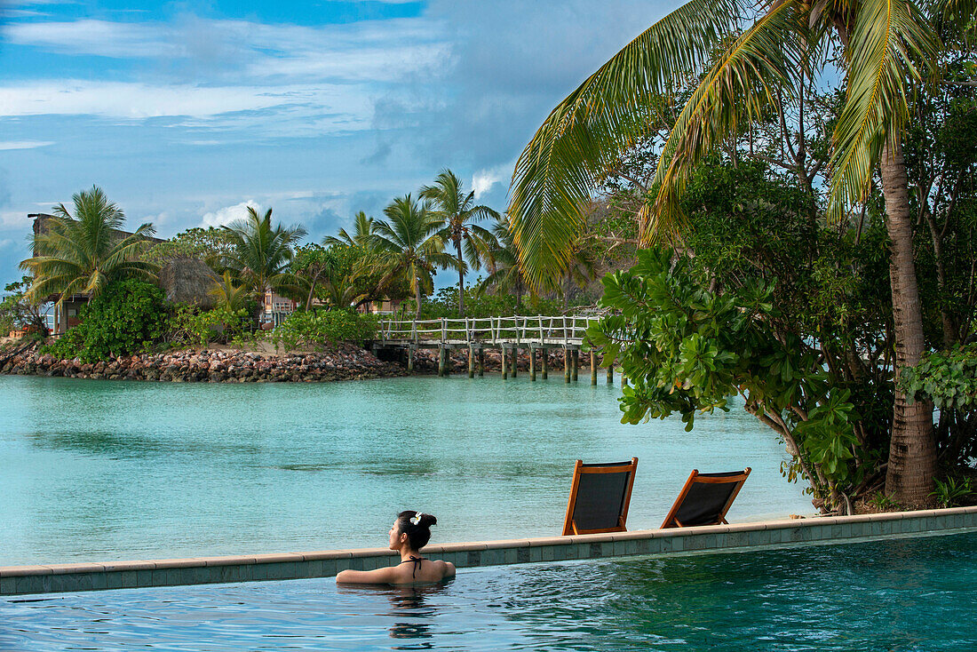 Nice asian woman in the infinity pool at Likuliku Resort, Malolo Island Mamanucas island group Fiji