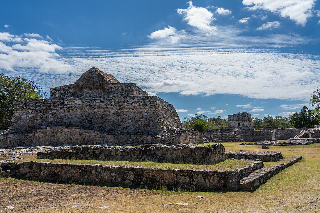 In the foreground is the back of the Temple of the Fisherman, with the Round Temple or Observatory in the distance in the ruins of the Post-Classic Mayan city of Mayapan, Yucatan, Mexico.