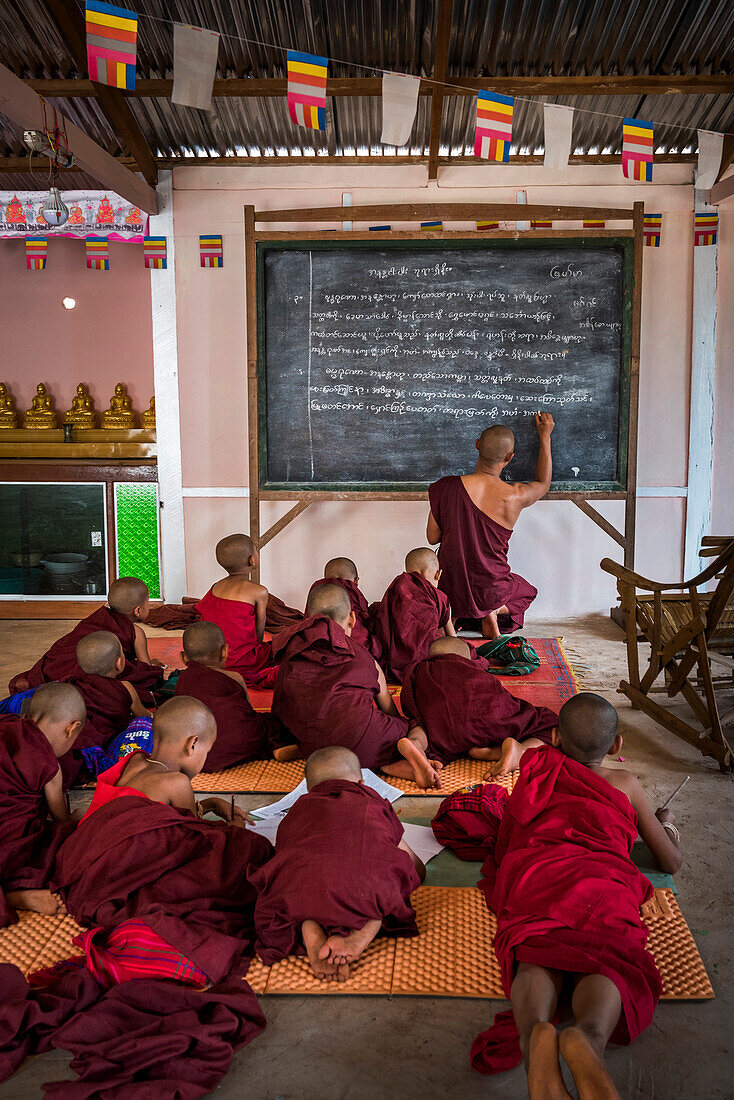 Monk teaching young novice monks at a Buddhist temple at Pindaya, Shan State, Myanmar (Burma)