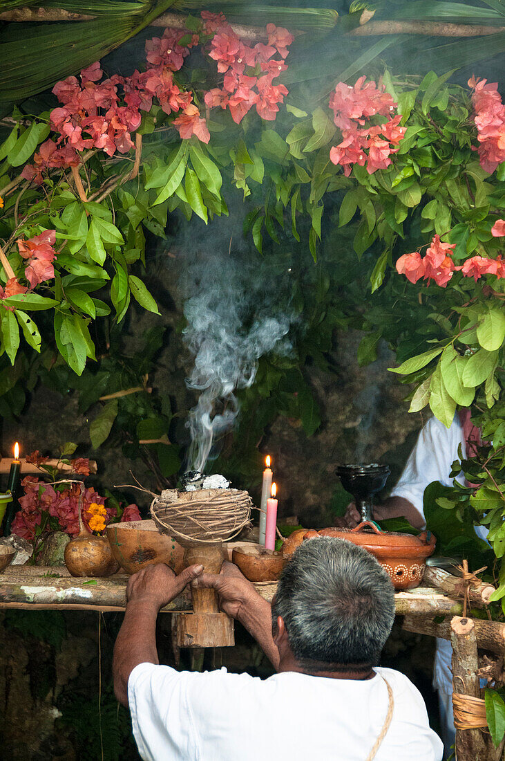 Shaman leading Maya ritual with burning copal resin at Tres Reyes Maya village, Riviera Maya, Mexico.