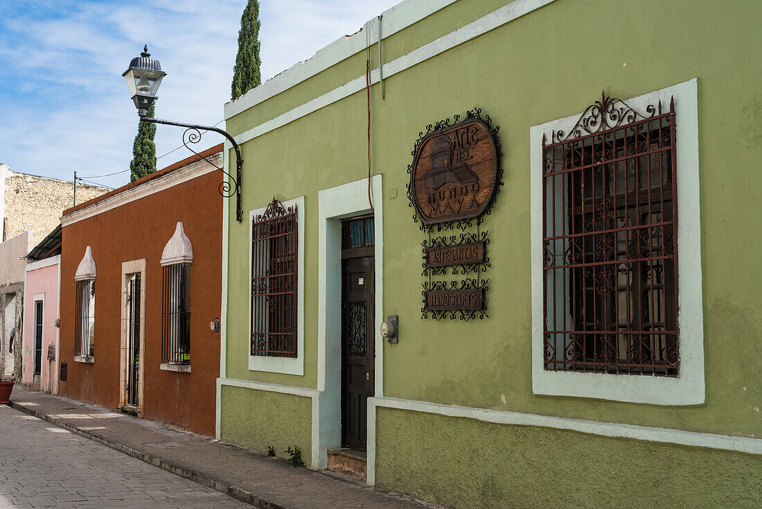 Painted Spanish colonial buildings on the Calzada de los Frailes in Valladolid, Yucatan, Mexico.