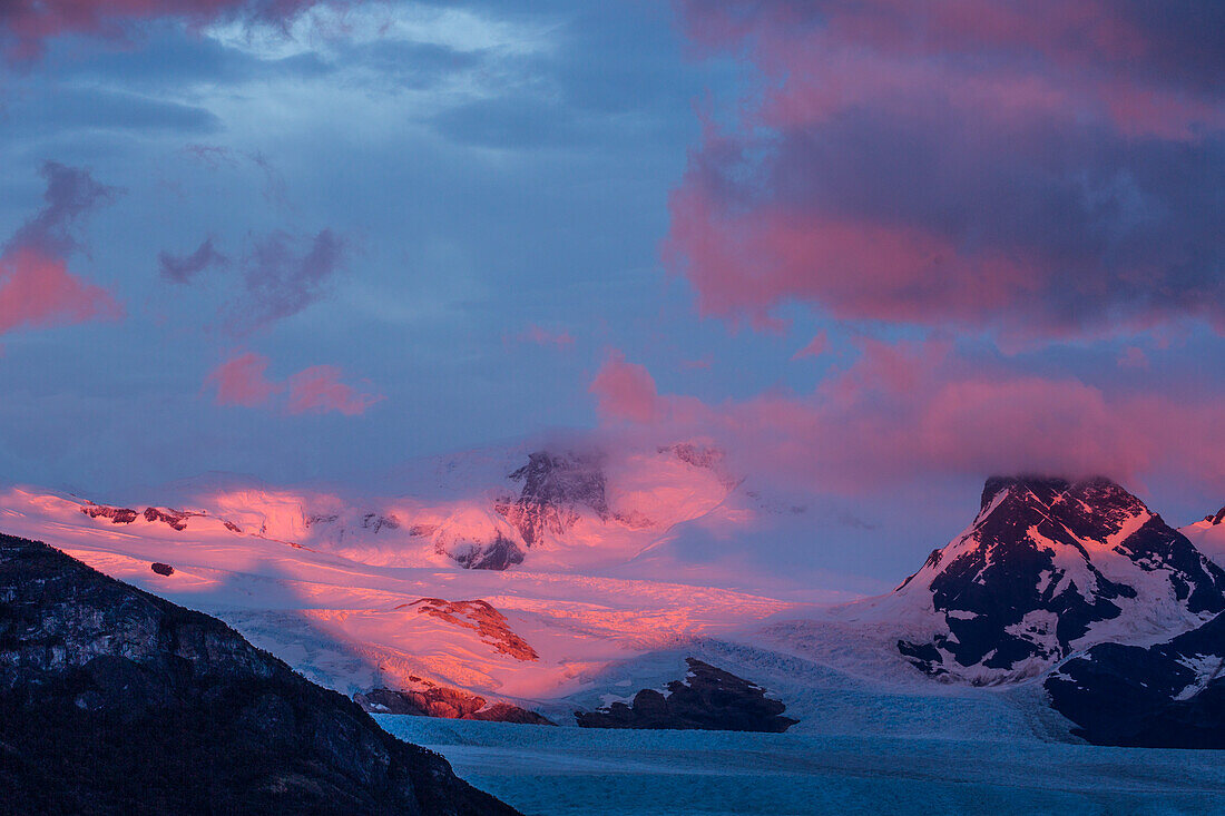 A pastel sunrise over the Perito Moreno Glacier in Los Glaciares National Park near El Calafate, Argentina. A UNESCO World Heritage Site in the Patagonia region of South America.