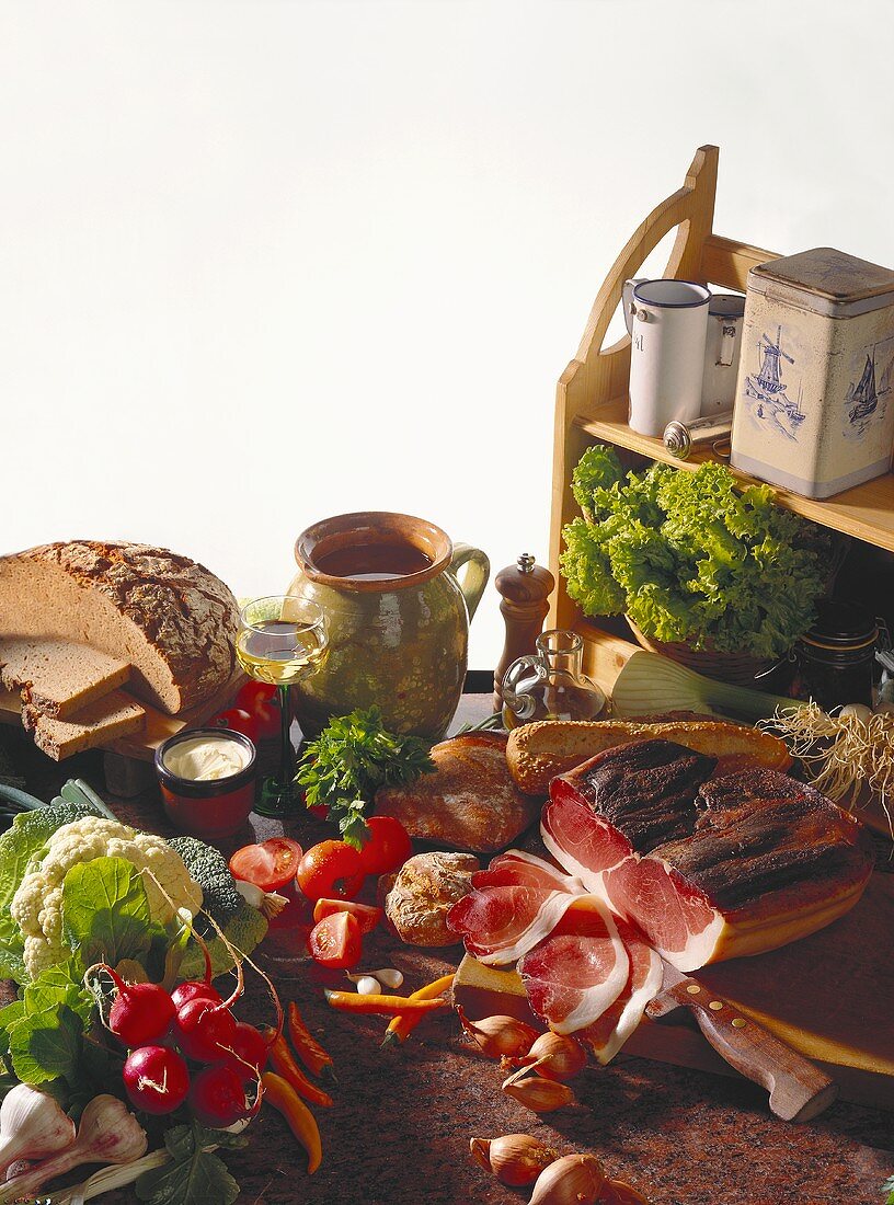 Rural snack ingredients: vegetables, bread, fat, ham, wine 