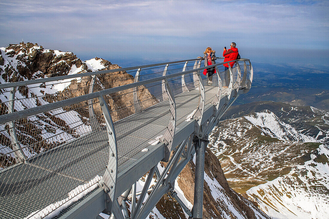 View point of The Observatory Of Pic Du Midi De Bigorre, Hautes Pyrenees, Midi Pyrenees, France. The 12m Ponton dans le ciel, a glass walkway high above the Pyrenees at Pic du Midi de Bigorre, a 2877m mountain in the French Pyrenees, home to an astronomical observatory and visitors centre. The observatory is acccessible from the village of La Mongie by cablecar. Tourists often visit in time for the spectacular sunset across the mountains.