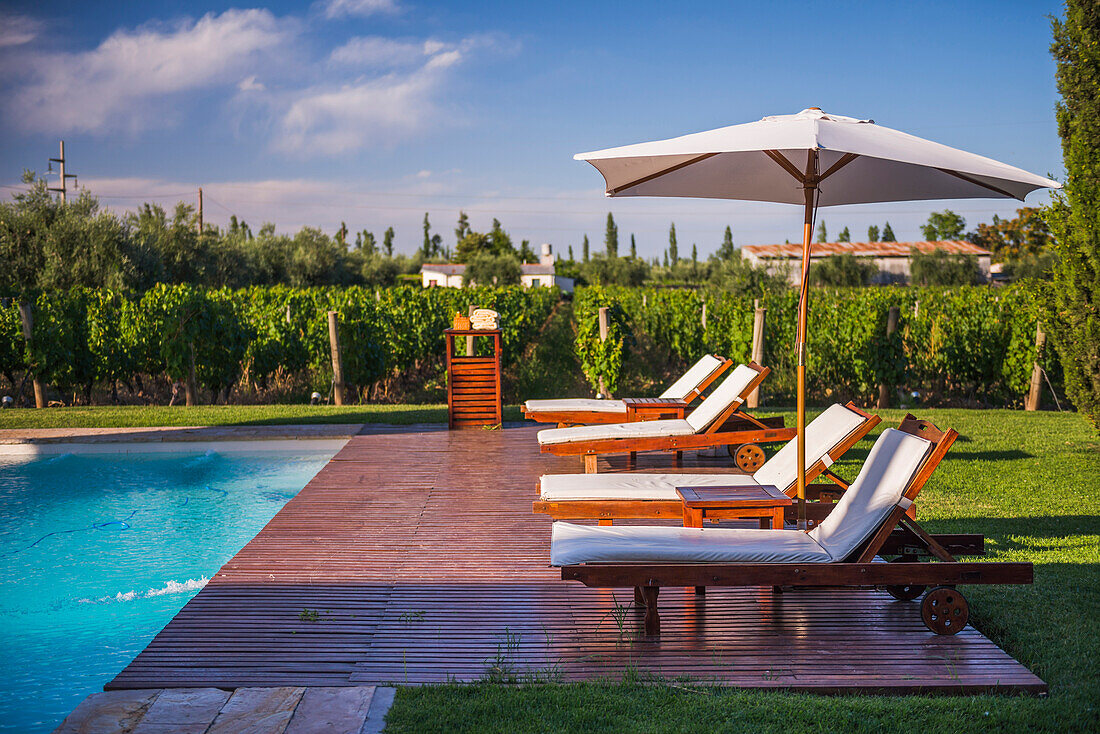 Deck chairs by the swimming pool at Resort Club Tapiz Boutique Hotel in the Maipu area of Mendoza, Mendoza Province, Argentina