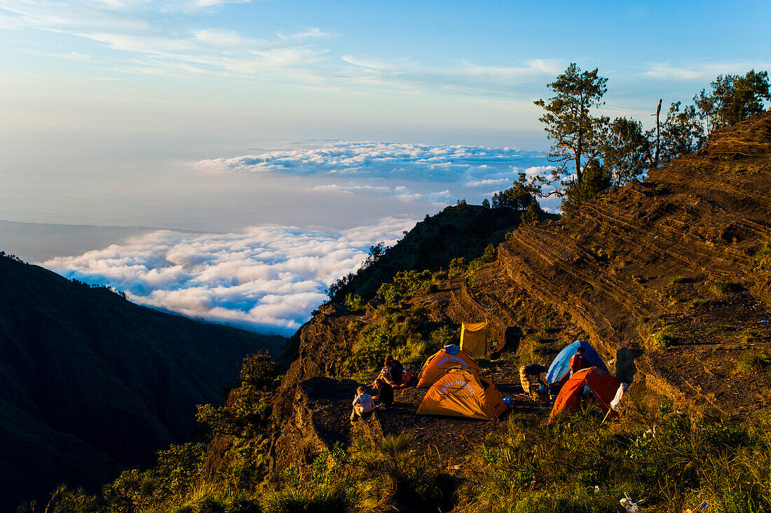 Camping at the Second Night Campsite on the Three Day Mount Rinjani Trek, Lombok, Indonesia. Much of the three day Mount Rinjani trek is spent walking above the clouds. Camping above the clouds on both nights is one of the highlights, with stunning views of the surrounding scenery. Mount Rinjani, (Gunung Rinjani in Indonesian) is an active volcano on Lombok island, Indonesia, whose summit of 3726m, makes it the second highest volcano in Indonesia.