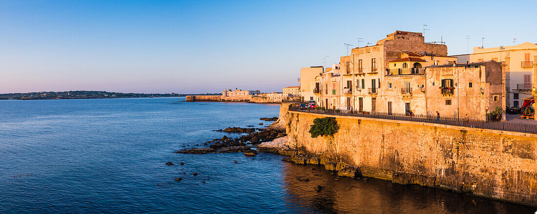 Panoramic photo of Ortigia Old City at sunrise, with Ortigia Castle (Castello Maniace, Castle Maniace) in the background, Syracuse (Siracusa), UNESCO World Heritage Site, Sicily, Italy, Europe. This is a panoramic photo of Ortigia Old City at sunrise, with Ortigia Castle (Castello Maniace, Castle Maniace) in the background, Syracuse (Siracusa), UNESCO World Heritage Site, Sicily, Italy, Europe.