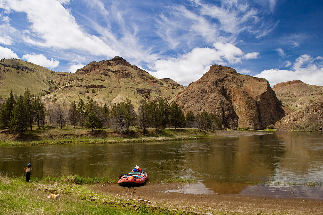 Woman, dog and raft on the John Day River at Cathedral Rock, northeastern Oregon.
