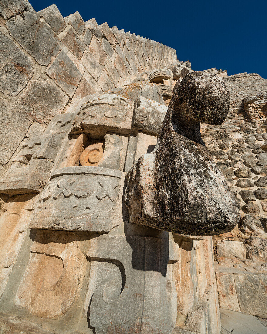 A row of Chaac masks line the stairway on the west facade of the Pyramid of the Magician, also known as the Pyramid of the Dwarf in the pre-Hispanic Mayan ruins of Uxmal, Mexico. Chaac is the rain god deity of the Maya.