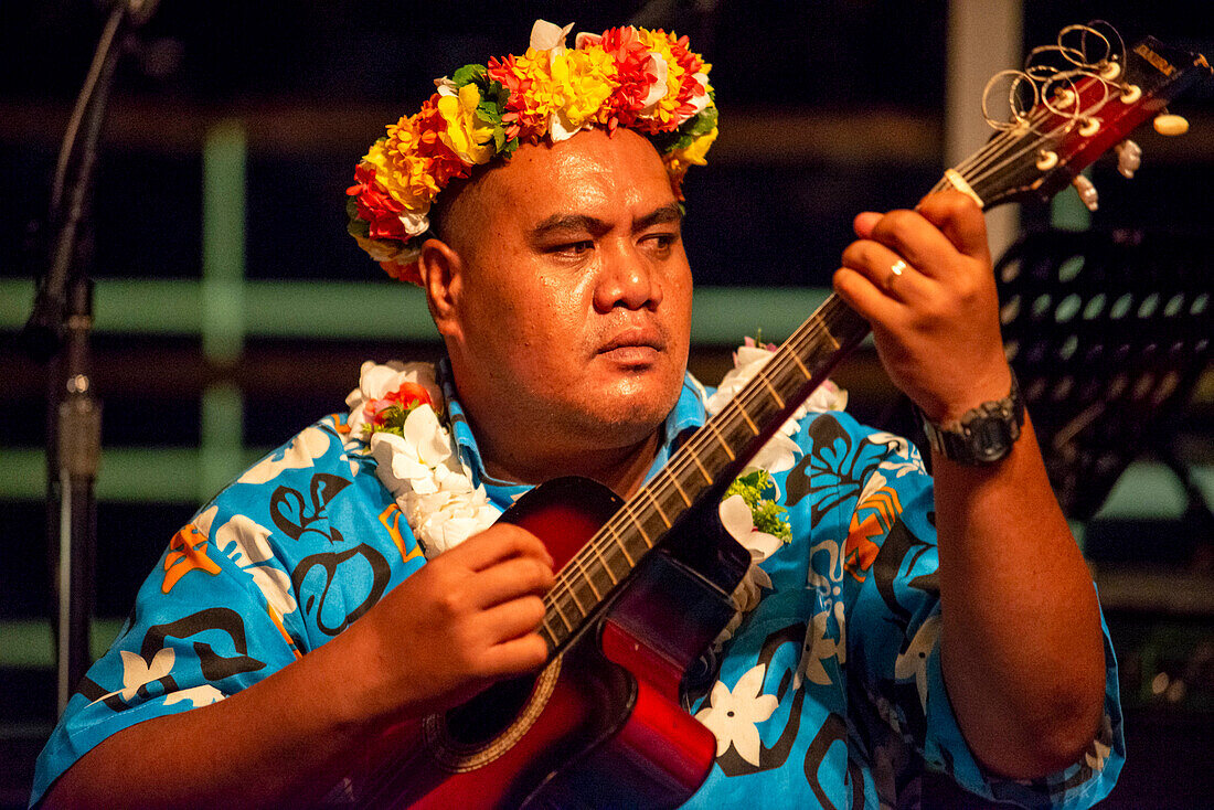 Entertainment group singing in the Paul Gauguin cruise ship. France, French Polynesia, Polynesian, South Pacific.