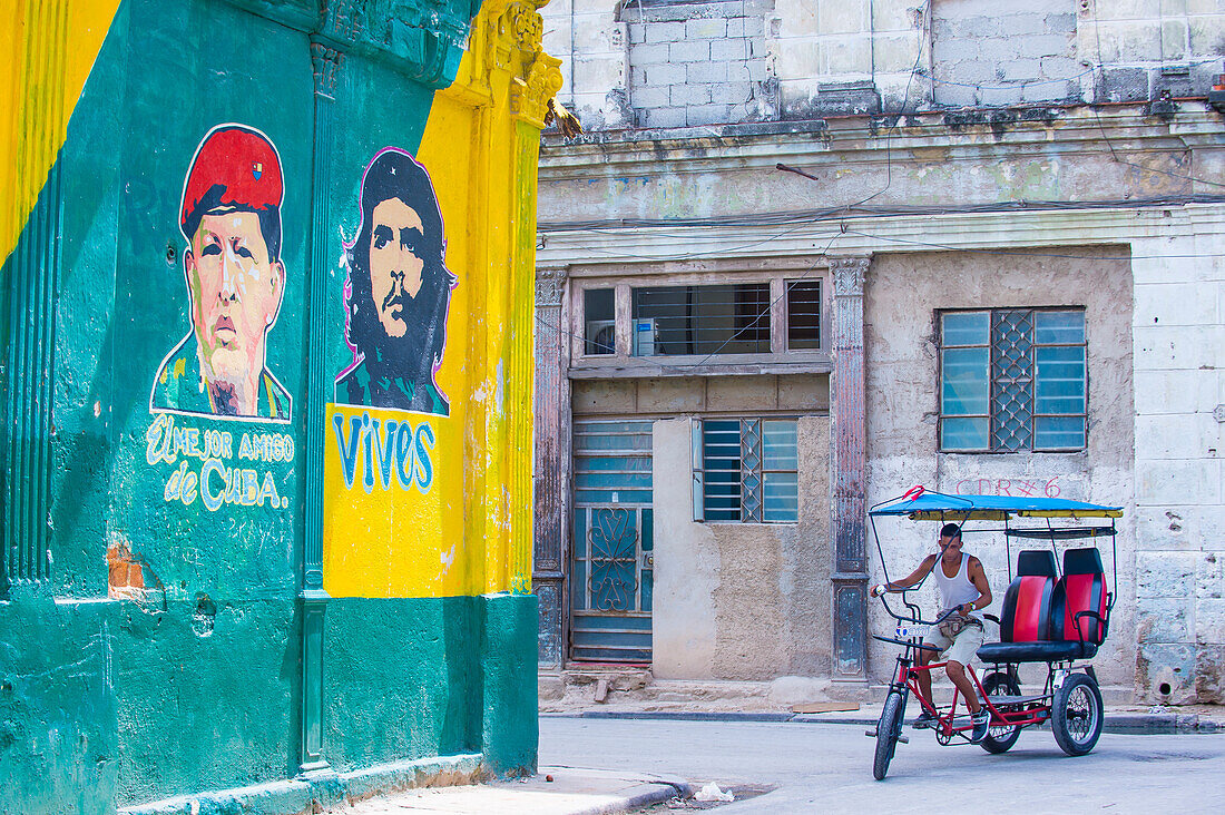 A Cuban rickshaw driver in old Havana street. Rickshaw are a popular way of transport in Cuba