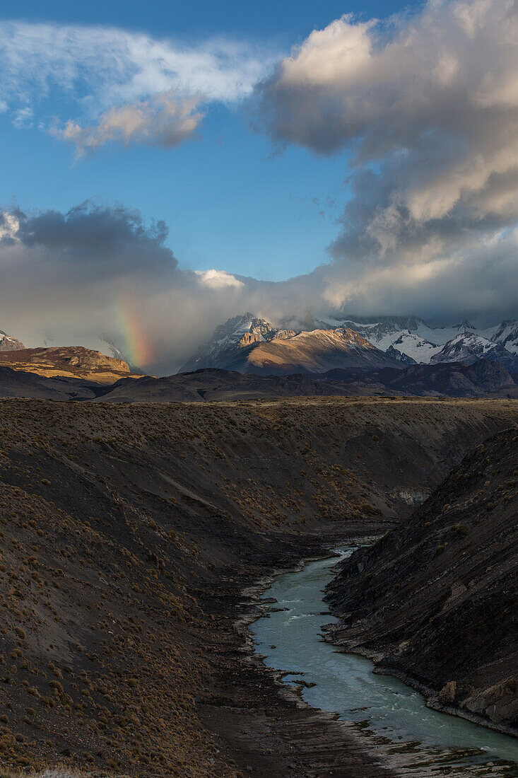 Clouds obscure the Fitz Roy Massif in Los Glaciares National Park near El Chalten, Argentina. A UNESCO World Heritage Site in the Patagonia region of South America. In the foreground is the canyon of the Rio de las Vueltas.