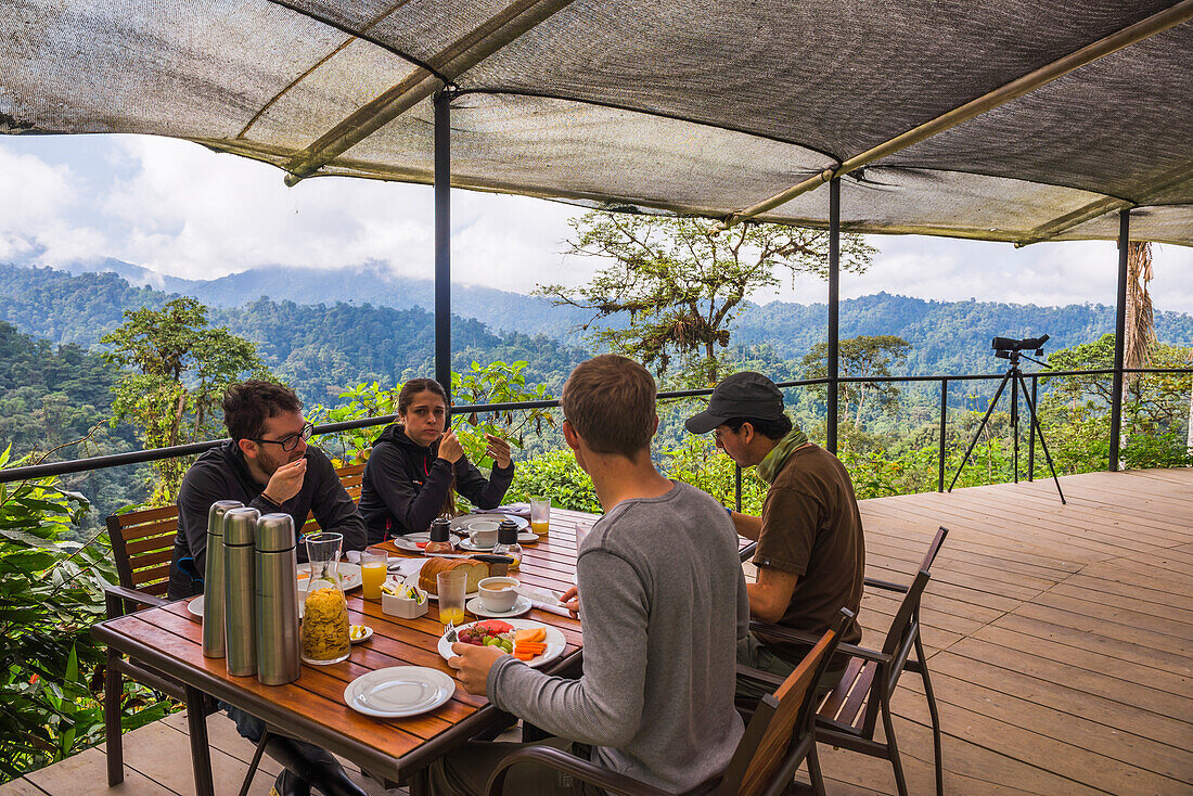 Tourist having breakfast in the jungle at the Sky Life Centre at Mashpi Cloud Forest in the Choco Rainforest, Ecuador, South America