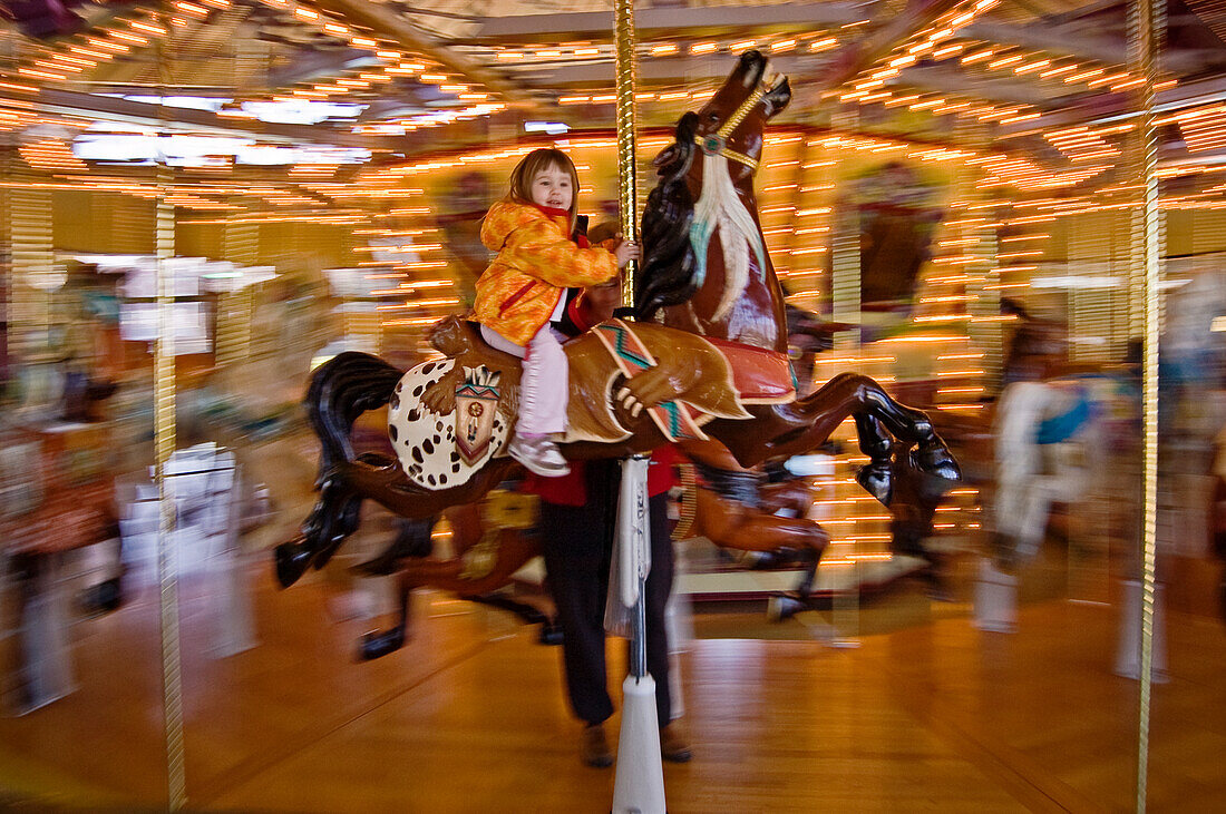 Young girl on horse at Salem's Riverfront Carousel; Salem, Oregon.