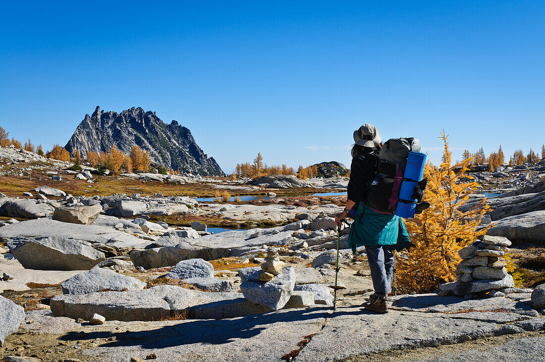 Backpacker hiking in the Upper Enchantments, Alpine Lakes Wilderness, Washington.