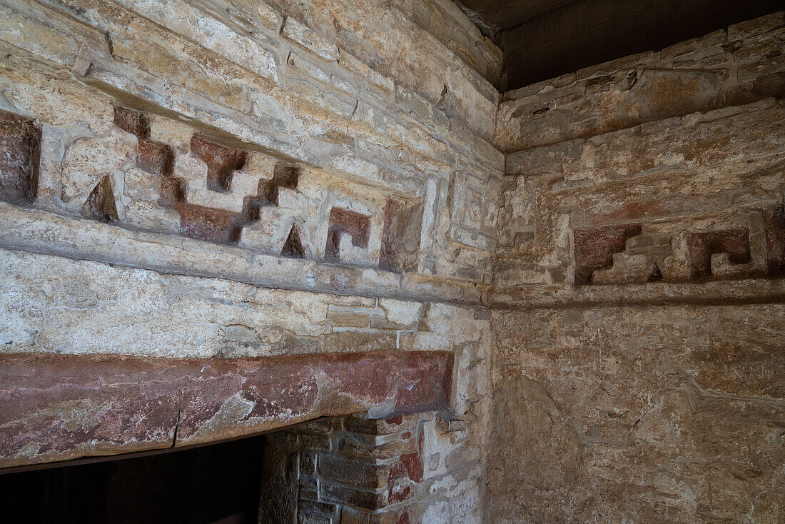 Mixtec-style stone fretwork with original red paint in the entrance to Tomb 1, the burial site of Lord Nine Flower, at the ruins of the Zapotec city of Zaachila in the Central Valley of Oaxaca, Mexico.