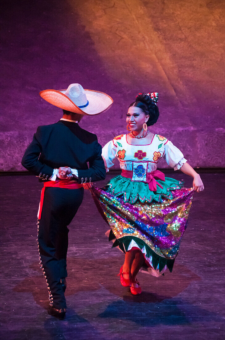 Dancers in traditional Mexican dress at Xcaret Mexico Espectacular dinner show; Xcaret theme park, Riviera Maya, Mexico.