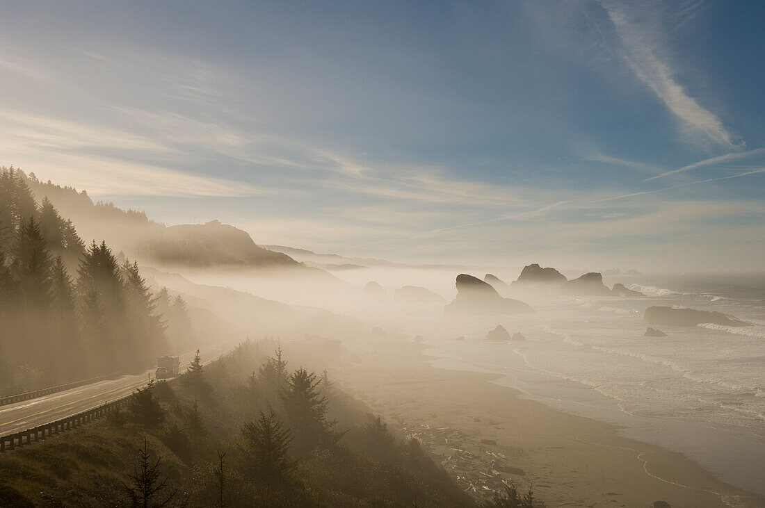 Beach, sea stacks and Highway 101 on a foggy morning; Cape Sebastian State Scenic Corridor, southern Oregon coast..