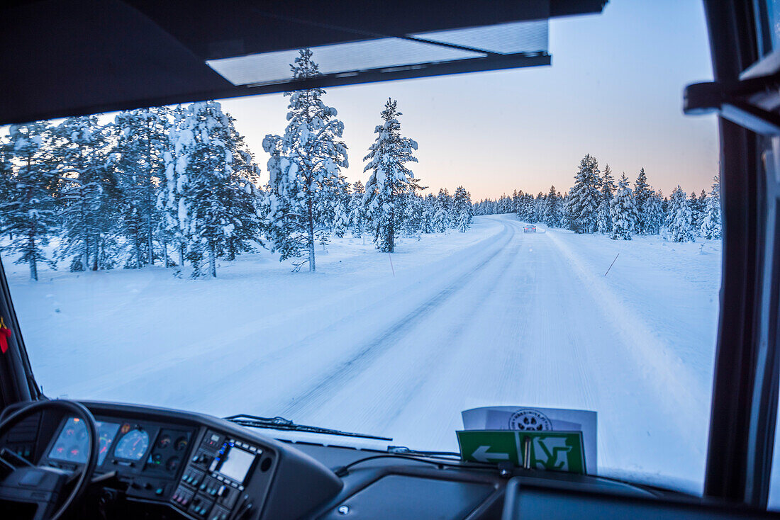 Bustransport auf vereisten Straßen in Finnisch-Lappland, Finnland