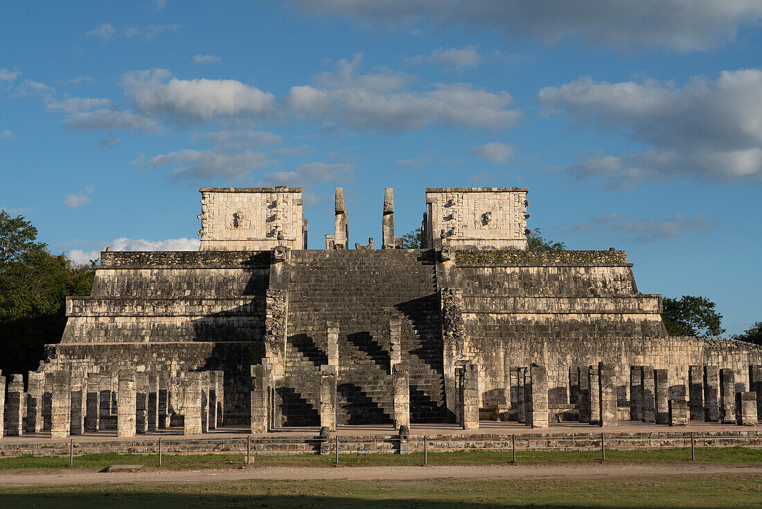 A statue of Chac Mool flanked by two Kukulkan serpent pillars atop the Temple of the Warriors in the ruins of the great Mayan city of Chichen Itza, Yucatan, Mexico. The Pre-Hispanic City of Chichen-Itza is a UNESCO World Heritage Site.