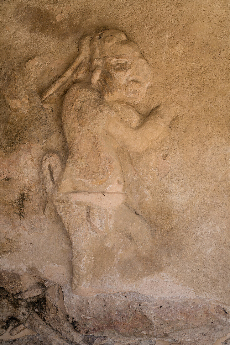 A figure carved in a stucco frieze on the Temple of Kukulkan in the ruins of the Post-Classic Mayan city of Mayapan, Yucatan, Mexico.