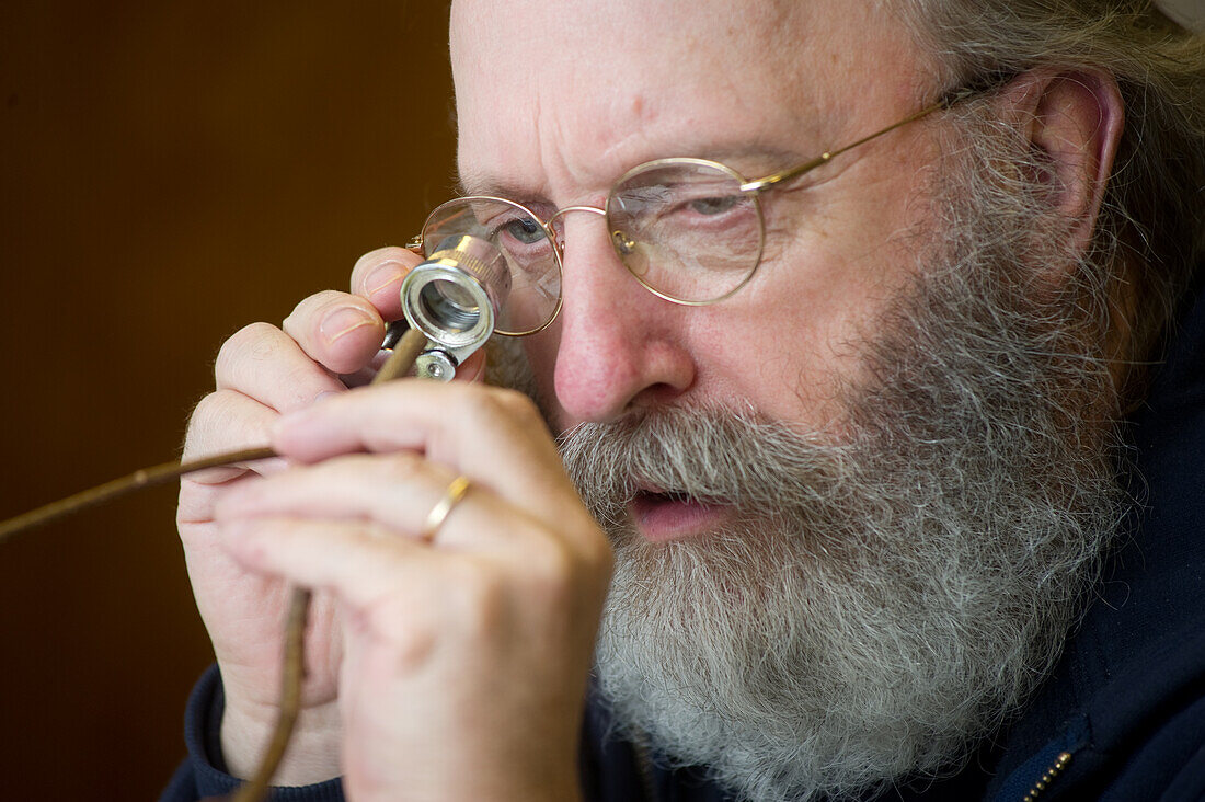 Person looking at plant stem through hand lens