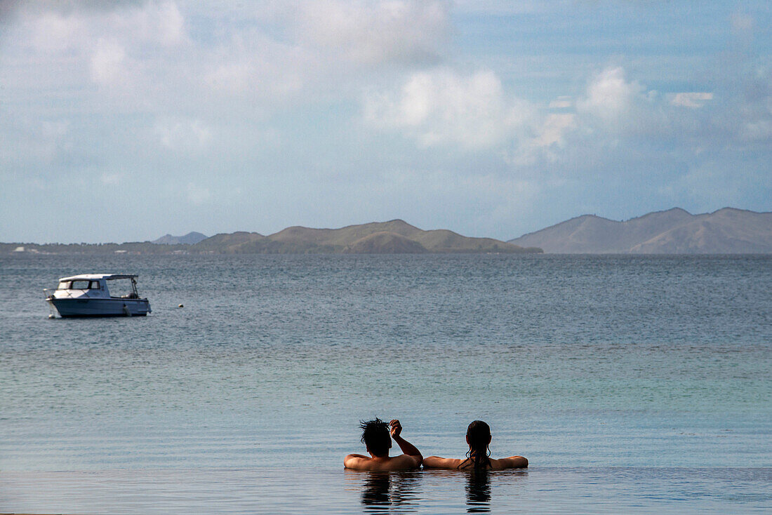 Couple in the infinity pool at Likuliku Resort, Malolo Island Mamanucas island group Fiji
