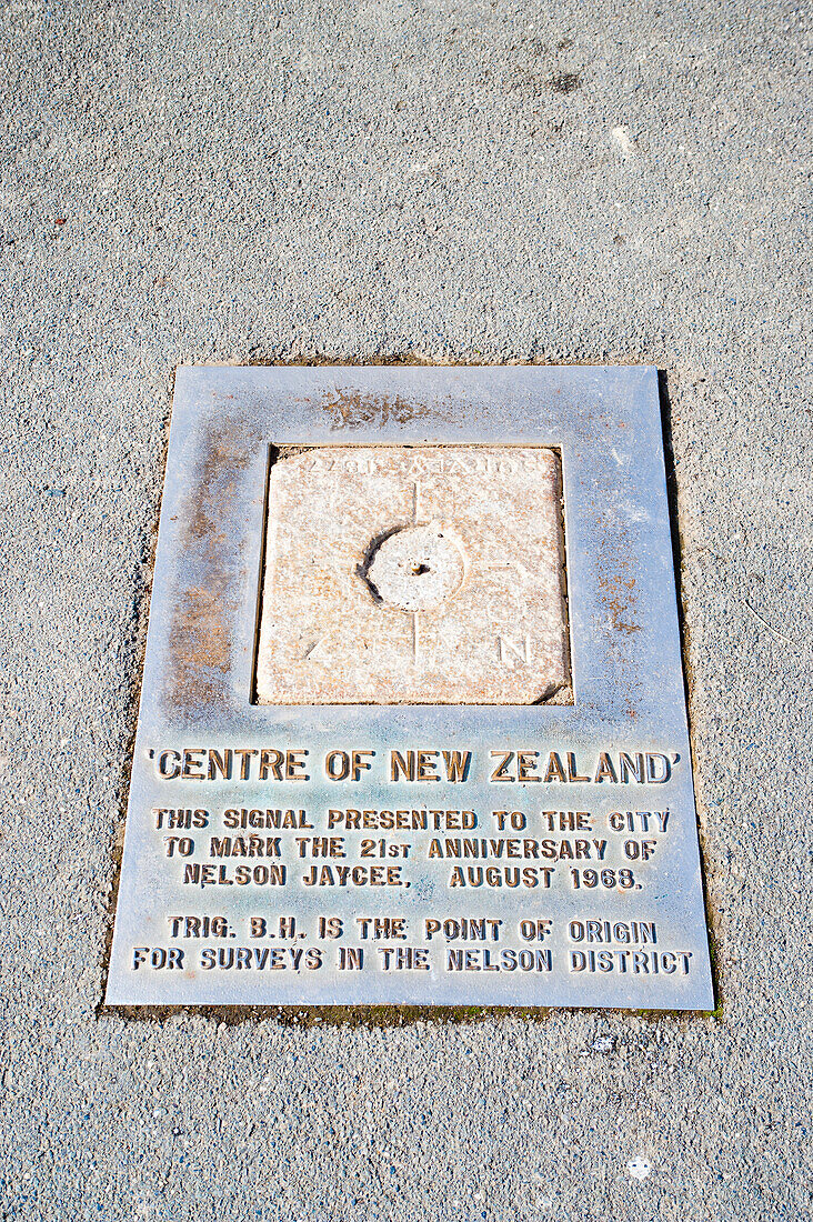 Centre of New Zealand Sign at Nelson, South Island, New Zealand. Nelson, home to the 'Centre of New Zealand', is a very picturesque city at the top of South Island, New Zealand. Its location on the coast, combined with the surrounding hills and mountains give rise to its wide variety of beautiful landscapes and scenery.