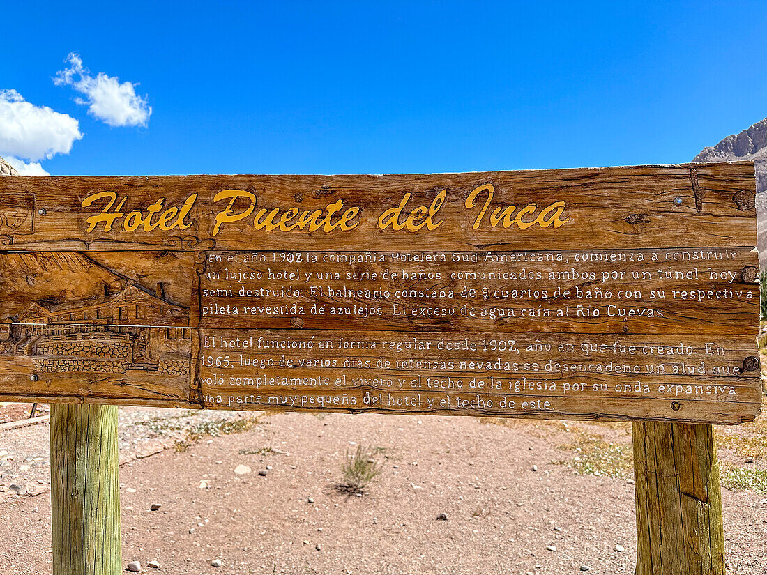 Wooden informational sign about the former Hotel Puente del Inca, destroyed in an avalanche in 1965. Mendoza, Argentina.