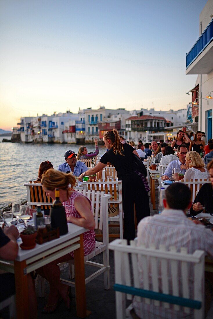 Cafe terrace with Little Venice in view, Mykonos, Greece