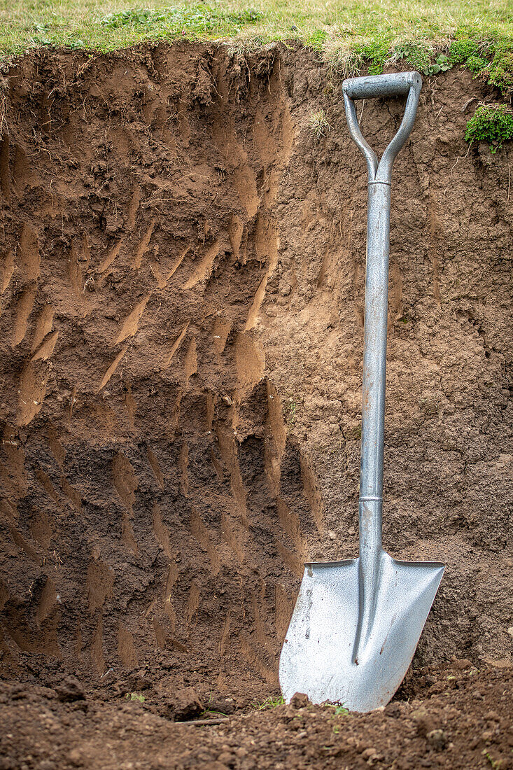 A shovel rests on the inside of a dirt pit, Debre Berhan, Ethiopia.