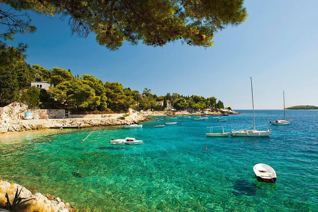 Foto von Booten auf dem kristallklaren Adriatischen Meer, Insel Hvar, Adriaküste, Dalmatien (Dalmacija), Kroatien. Dies ist ein Foto von Booten auf dem kristallklaren Adriatischen Meer, das die Insel Hvar an der Adriaküste Kroatiens umgibt.