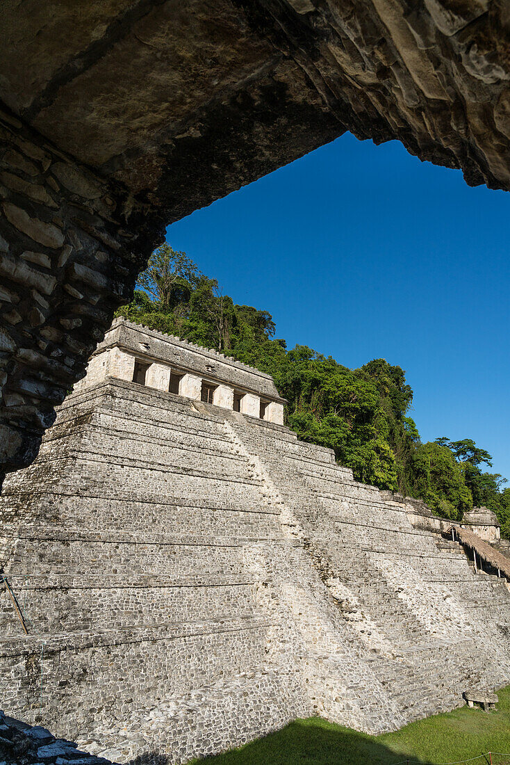 The Temple of the Inscriptions framed by an arch in the Palace at the ruins of the Mayan city of Palenque, Palenque National Park, Chiapas, Mexico. A UNESCO World Heritage Site.