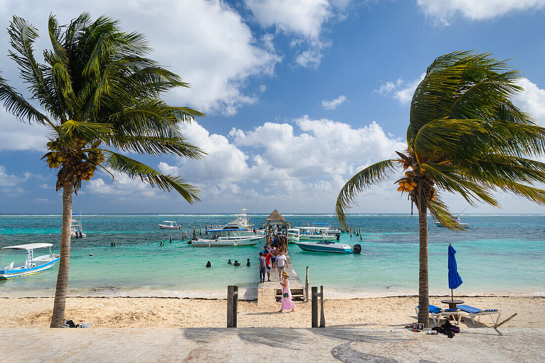 The malecon and Pelicanos Yacht Club pier in Puerto Morelos, Riviera Maya, Mexico.