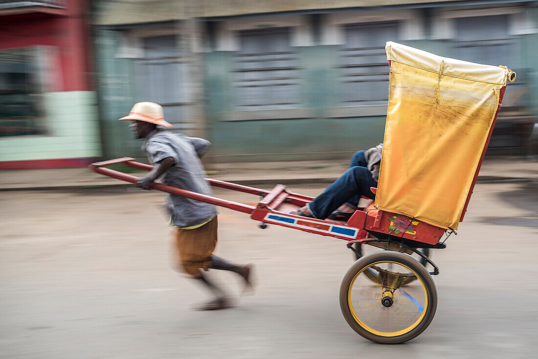 Man powered rickshaw (pousse-pousse) in Antisrabe, Vakinankaratra Region, Madagascar Central Highlands