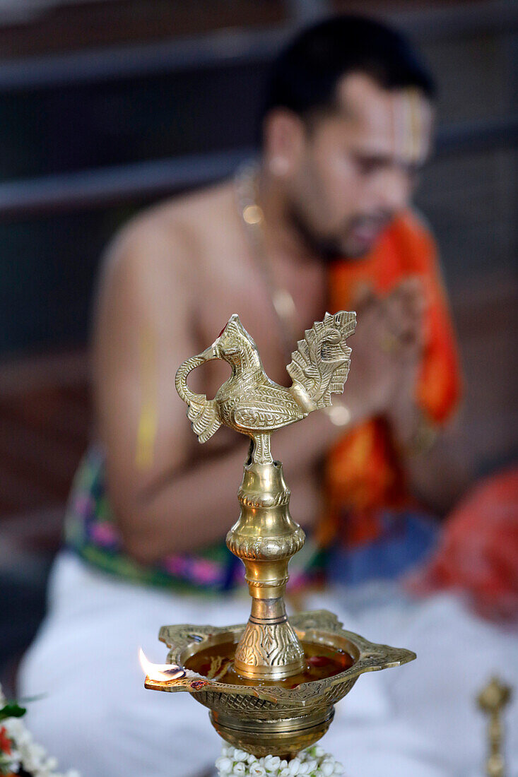 Sri Srinivasa Perumal Hindu temple, Hindu priest (Brahmin) performing puja ceremony and rituals, oil lamp, Singapore, Southeast Asia, Asia