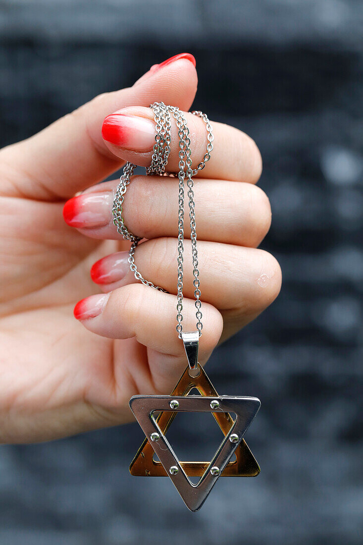Close up on hands of woman with a Star of David (Jewish Star) pendant, Vietnam, Indochina, Southeast Asia, Asia