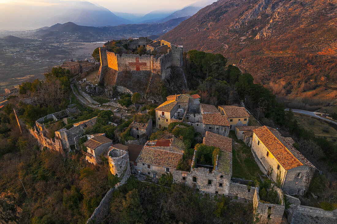Aerial view of the medieval castle of Vicalvi, with red cross painted on the perimetral wall, overlooking the old village at sunset, Vicalvi, Frosinone province, Ciociaria, Latium region, Lazio, Italy, Europe