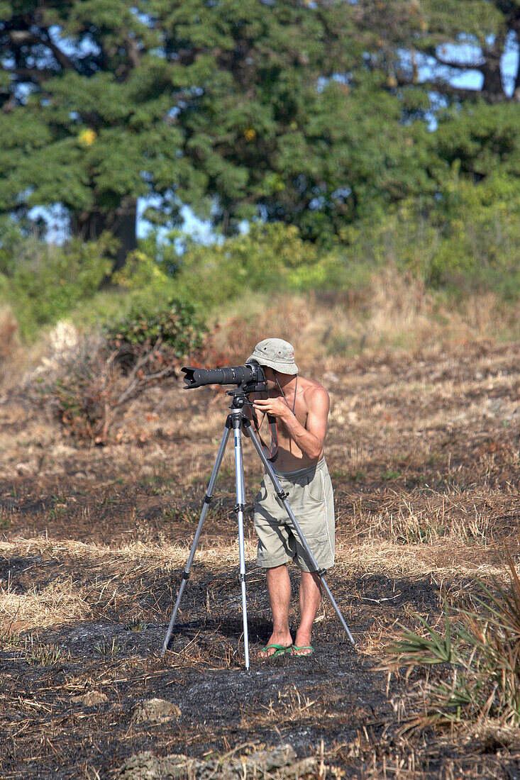 Photographer Taking Pictures On Tripod