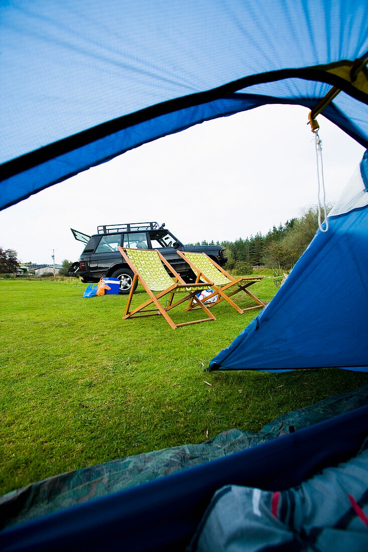 Deck Chairs And Car Through The Open Door Of The Tent