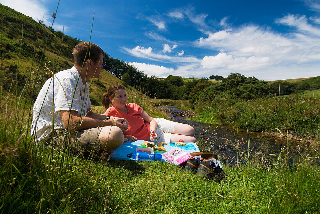 Couple Having Picnic Beside The River Exe
