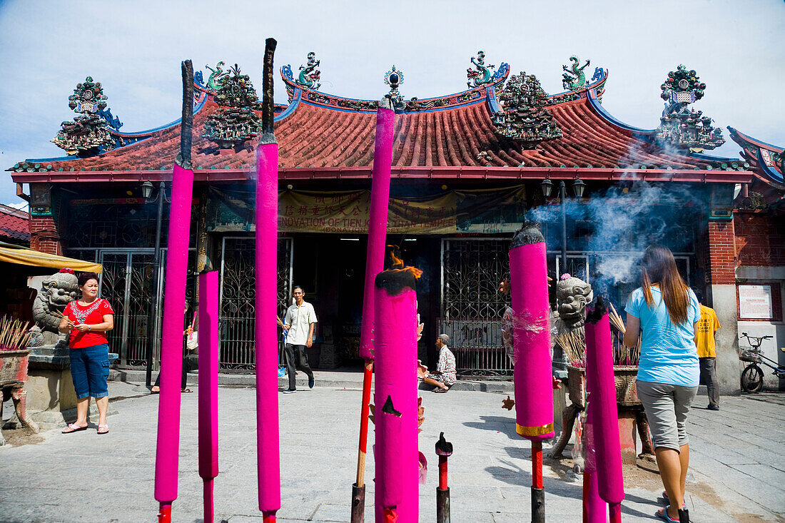 Worshippers Lighting Joss Sticks And Offering Up Prayers