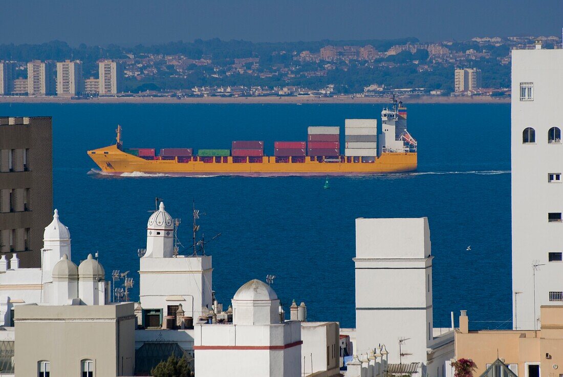 Cargo Ship Passing City Skyline