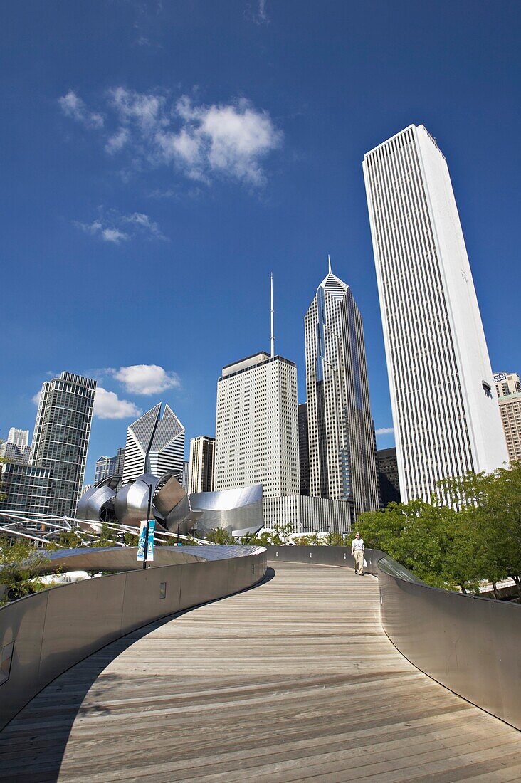 Man Walking Bp Amoco Bridge, With City Skyline In Background