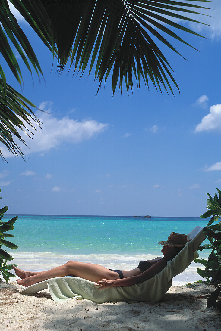 Seychelles, Praslin, Woman Relaxing On Beach; Cote D'Or Beach