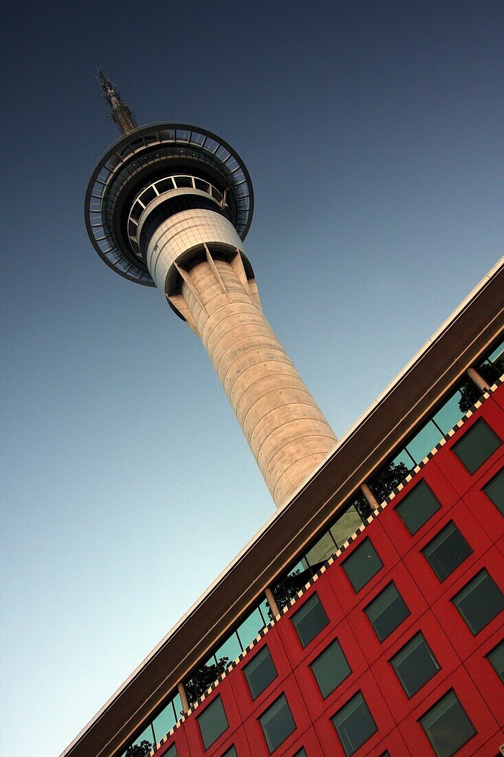 Sky Tower Placed Behind Modern Red Building