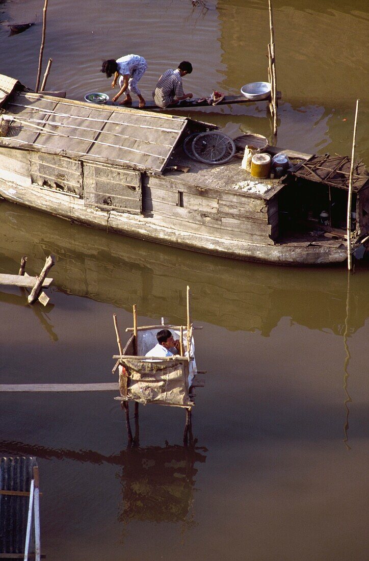 People Washing From Wooden Boat In Mekong River