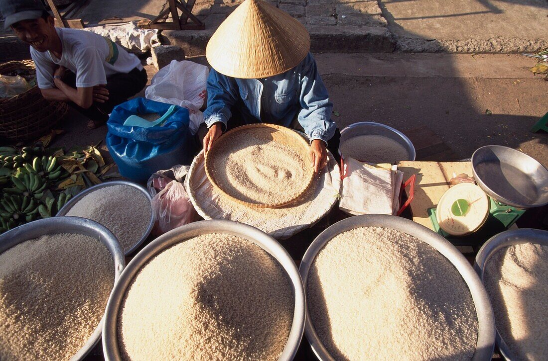 Woman In Conical Hat Sifting