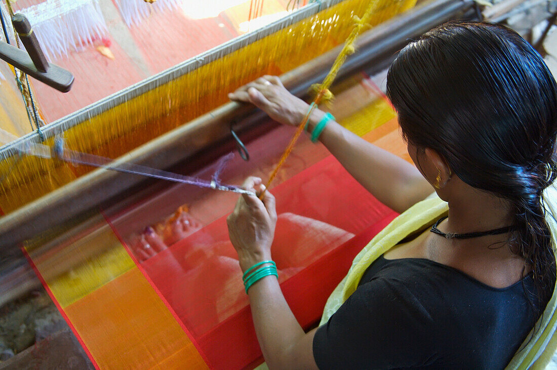 Woman Using Loom Weaving Fabric In Factory