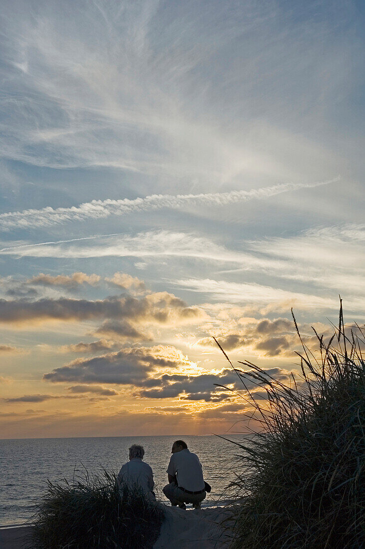 Two People Watching Sunset On Beach,Ear View, Jutland,Denmark